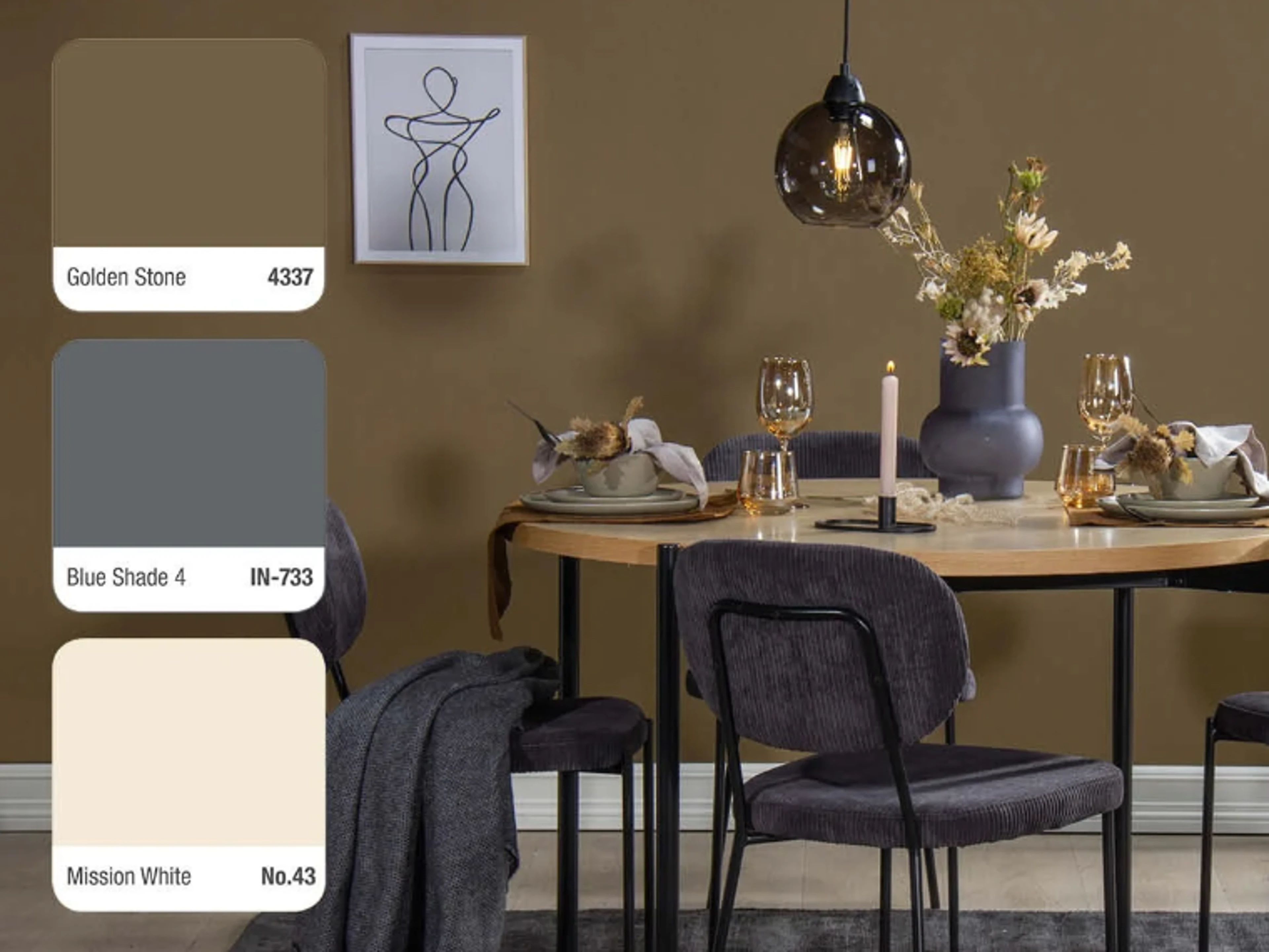 Dining area with golden brown walls, a round wooden table set with golden glasses, a candle and a floral arrangement, dark corduroy chairs and a glass pendant lamp, with three colour swatches on the left: Golden Stone 4337, Blue Shade 4 IN-733 and Mission White No.43.