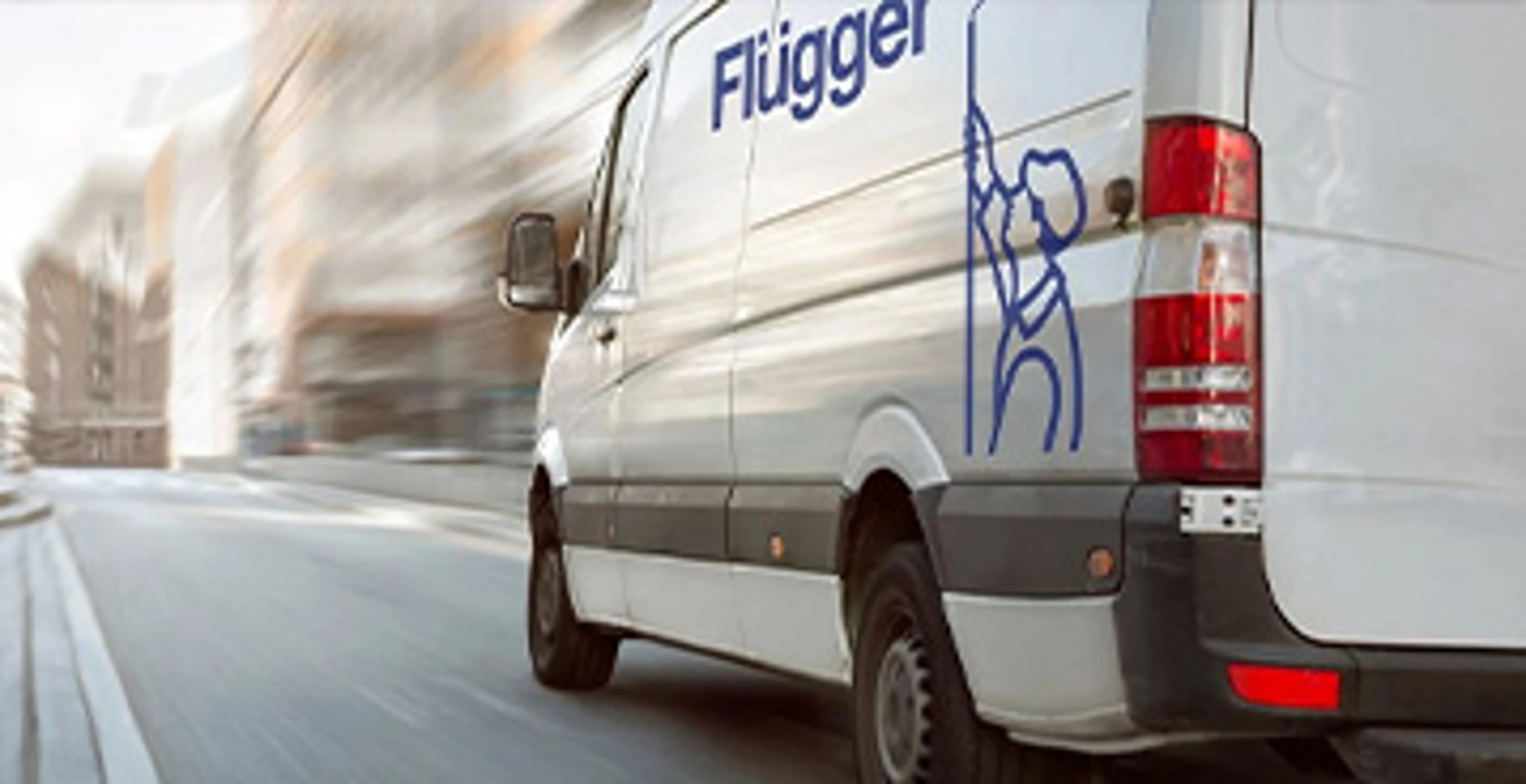 White Flügger service van driving on a road. The Flügger logo and the illustration of the painting boy are visible on the side of the car.