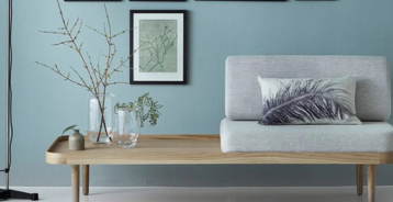 Living room with a blue-painted wall and modern Nordic interior design.