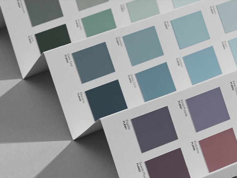 Flügger 80 (FL80) colour card with selected colour samples in blue, green and purple shades. The colour swatches are arranged on folded cards, with colour names and colour codes printed next to each swatch.