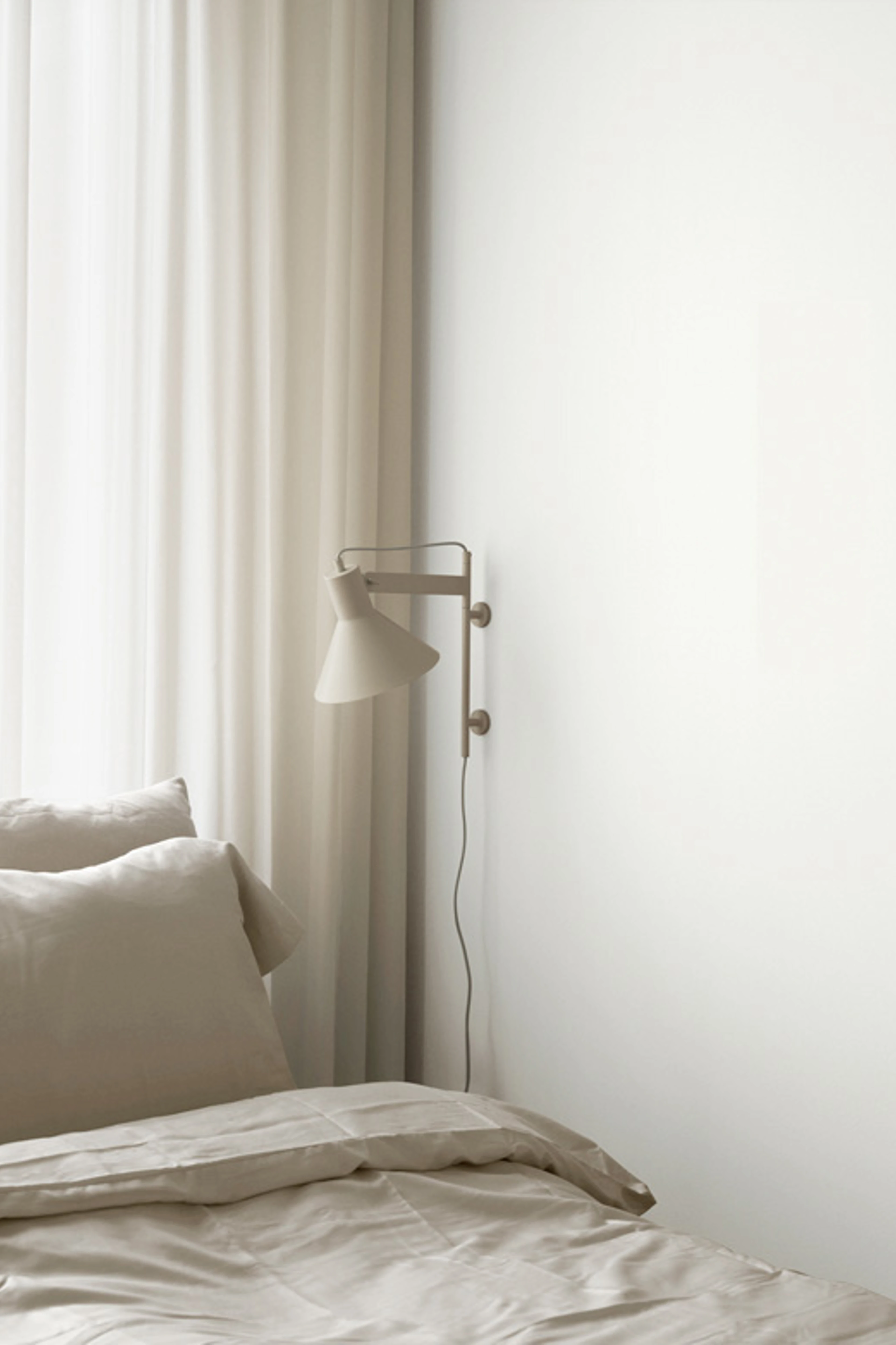 Soveværelse med seng, der har hvidt sengetøj. Hvid lampe på højre væg. Rummer et malet i farven White 01 fra Flügger.