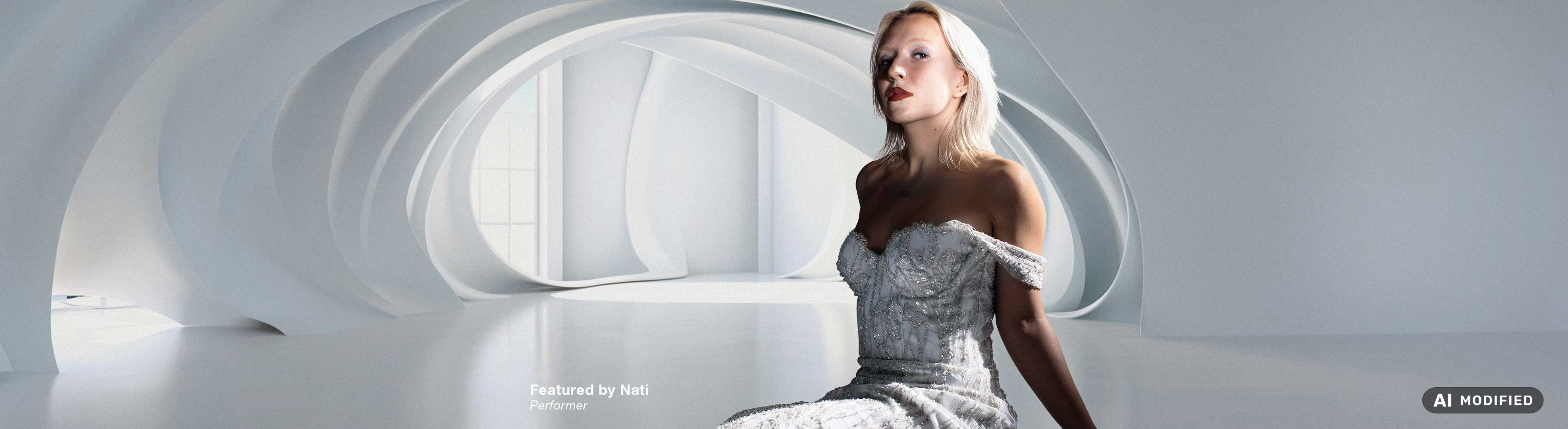 Person i en lys, detaljeret kjole sidder i et lyst, futuristisk rum med organiske, buede arkitektoniske former. De hvide og elfenbensfarvede nuancer i omgivelserne er inspireret af Flügger-farven Ivory (FL8050).