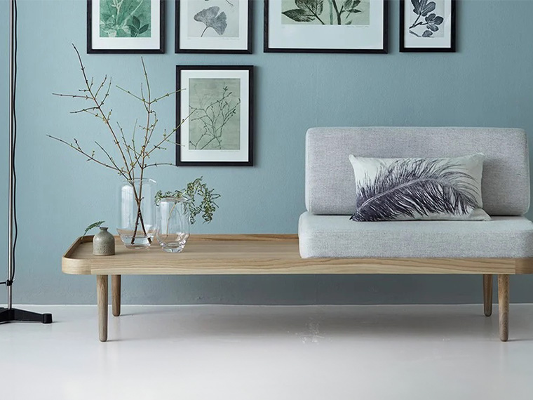 Living room with a blue-painted wall and modern Nordic interior design.