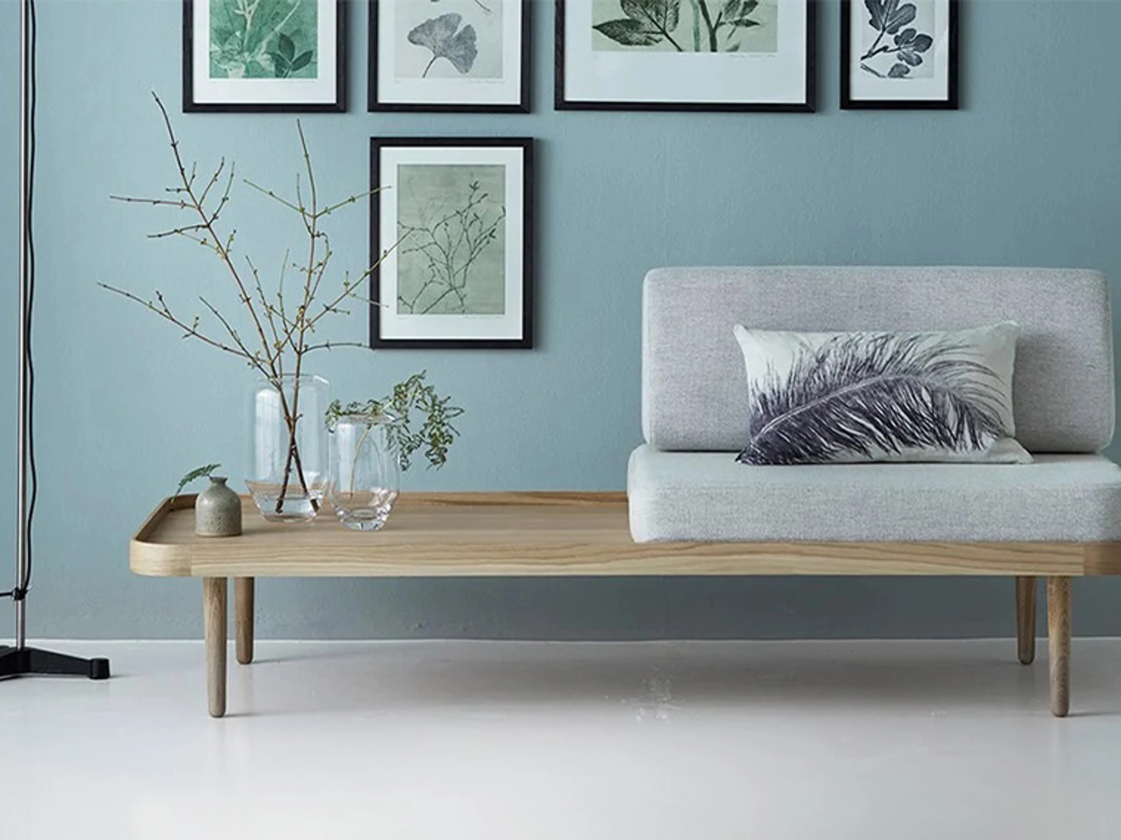 Living room with a blue-painted wall and modern Nordic interior design.