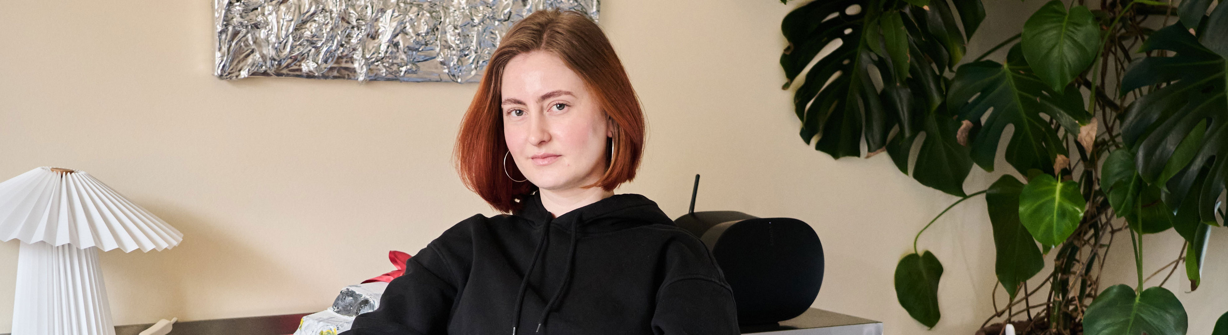 Mathilde der sidder ned og kigger ind i kameraet.